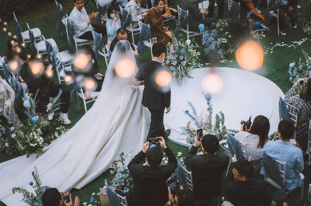 Bride and groom walk down an outdoor wedding aisle.